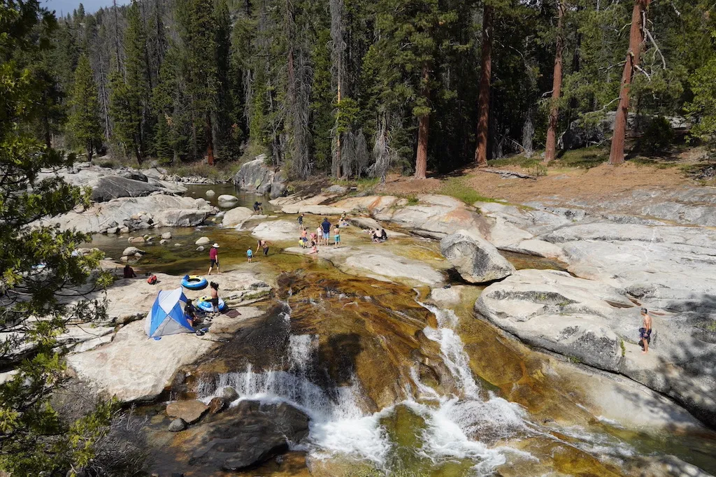 People are hanging out at the river beach.