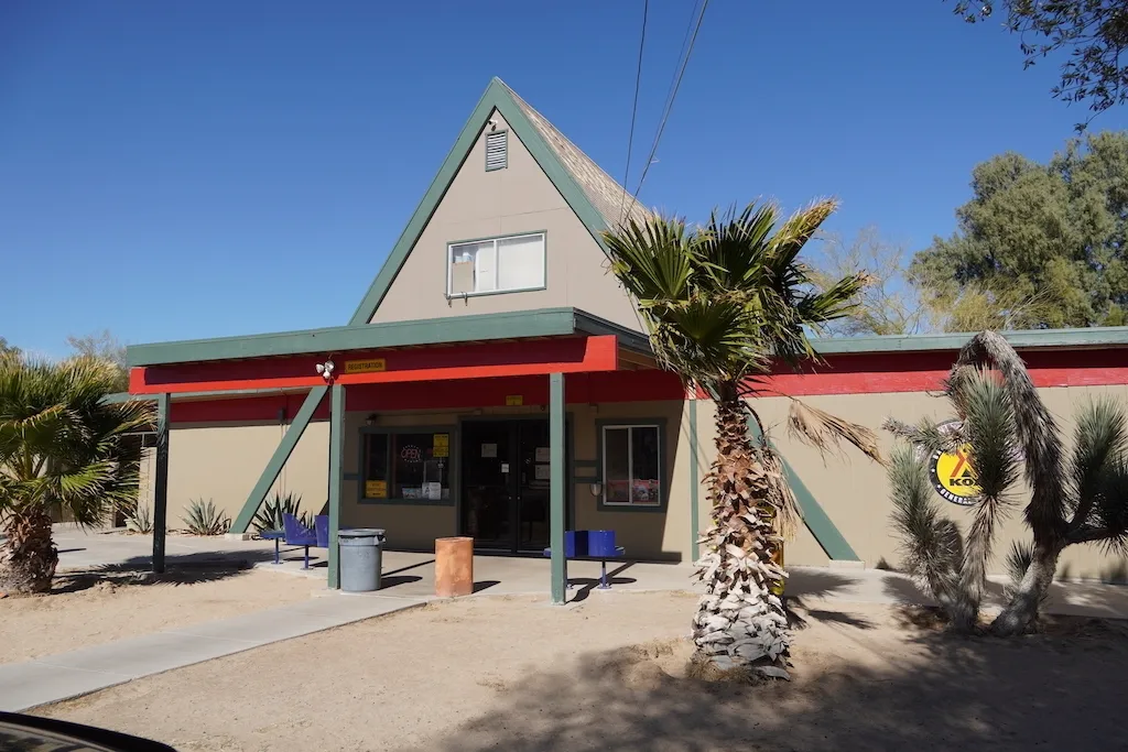 KOA Barstow and Calico's office building and some palm trees.