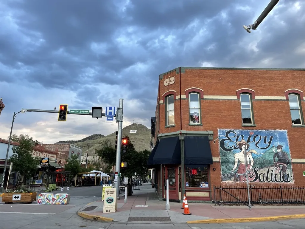 Red brick building with mountain background in Salida Downtown.