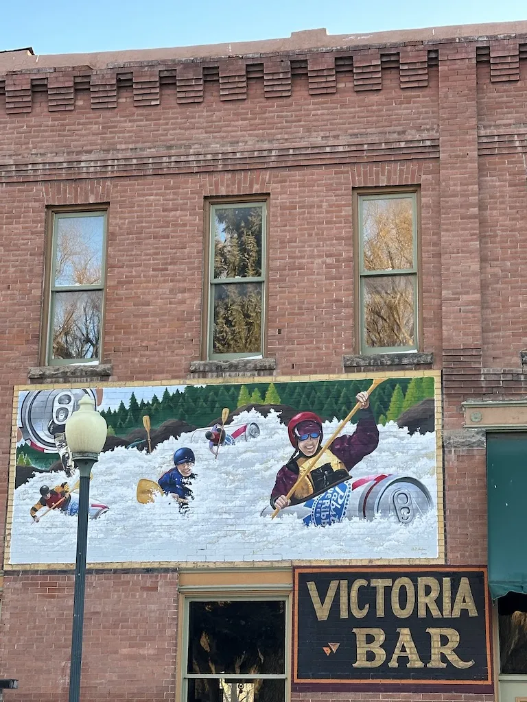 The mural of people are enjoying kayaks in white river.