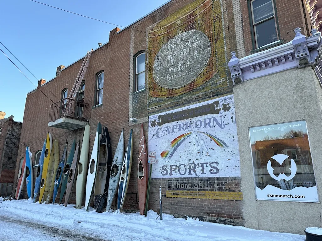 Many old kayak are standing by the brick wall in Salida downtown, Colorado.