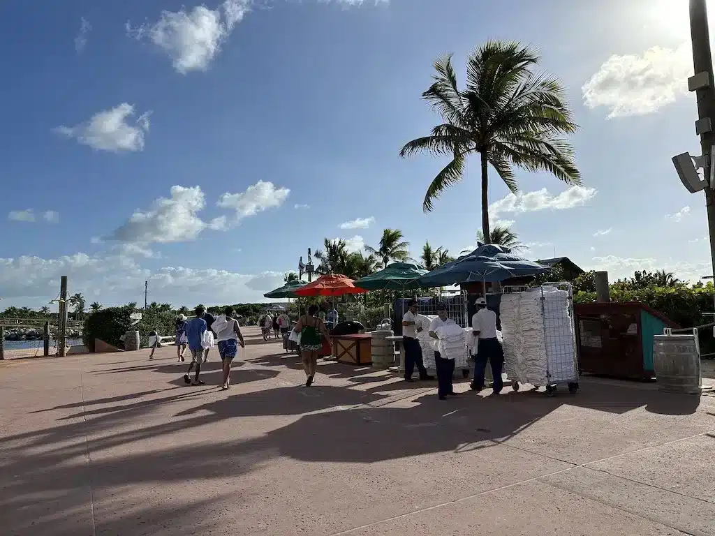 Disney Cruise staff are handing out white beach towels to the cruise guest at Castaway Cay port.