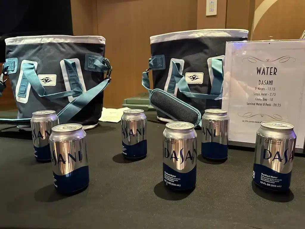 Six cans of Dasani water on the table.