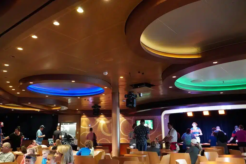 People are checking in the D lounge on Disney Cruise.