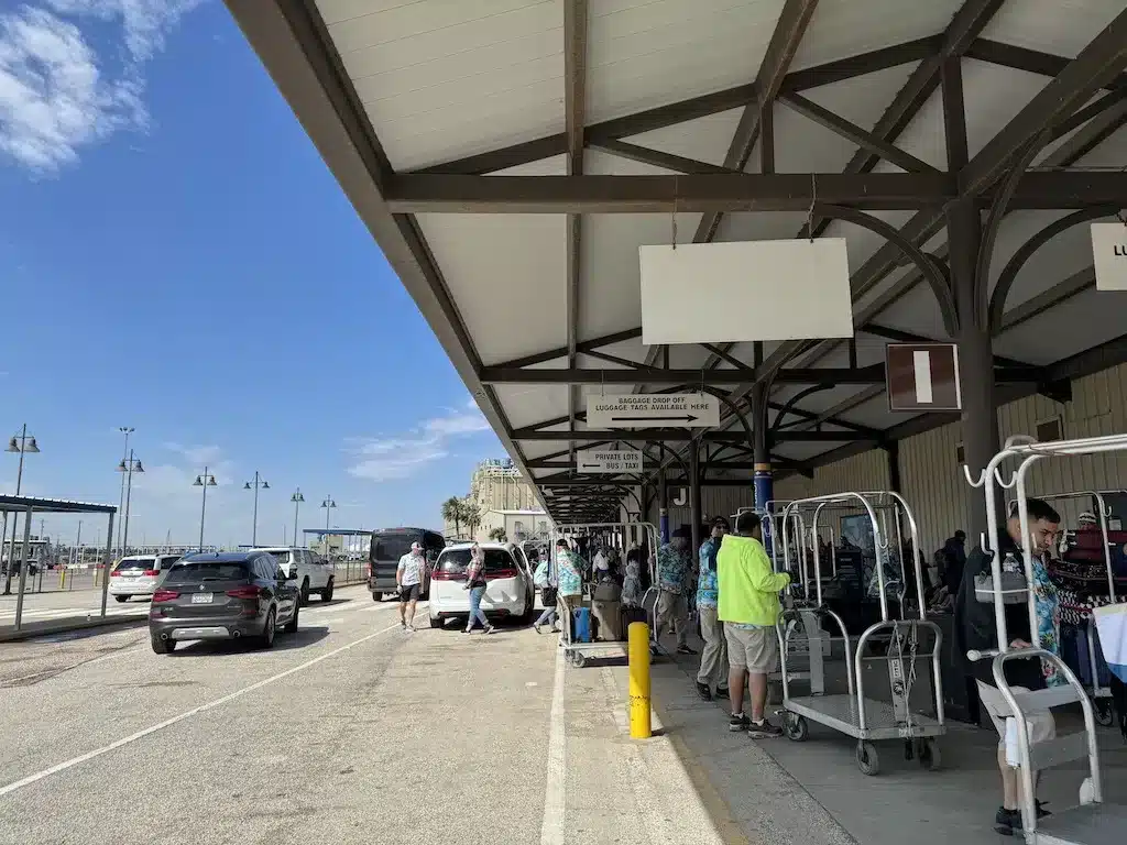 Disney Cruise staff are loading checked in luggage along the roadside at Galveston Port, in Texas.