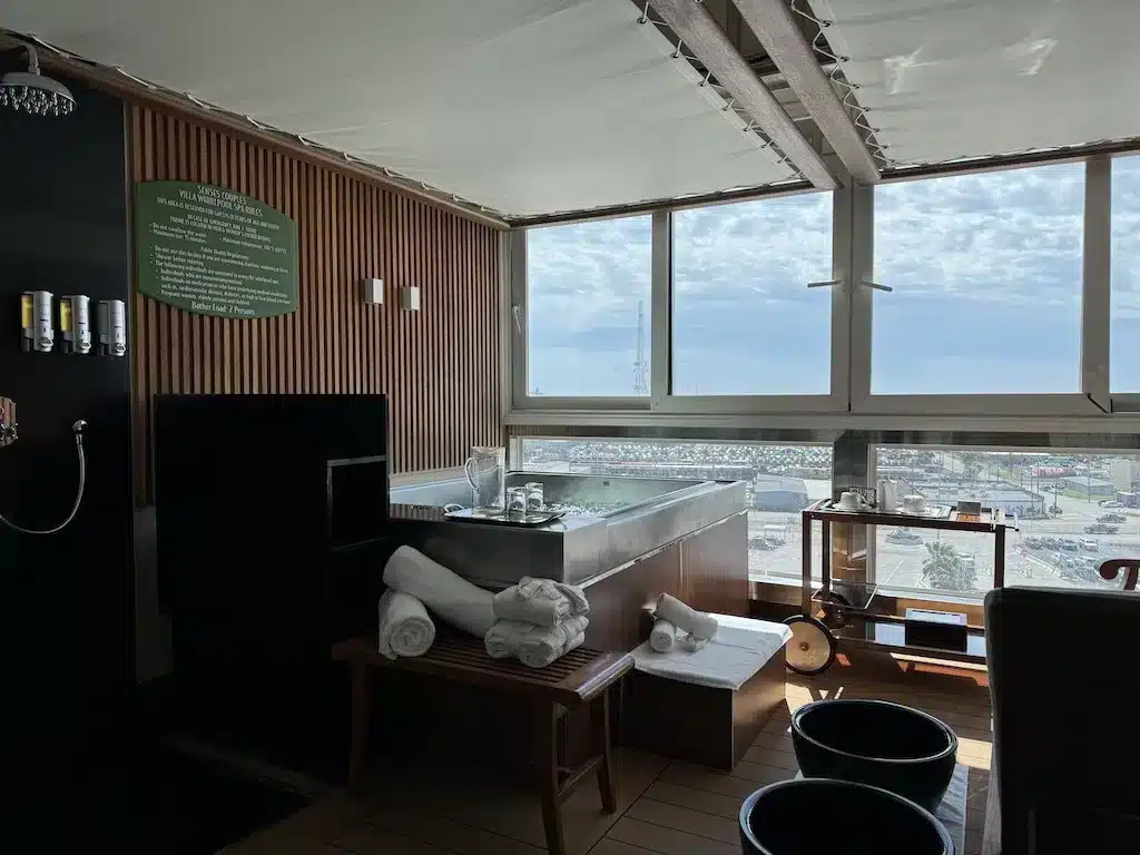 The gorgeous jacuzzi and shower room by the windows.