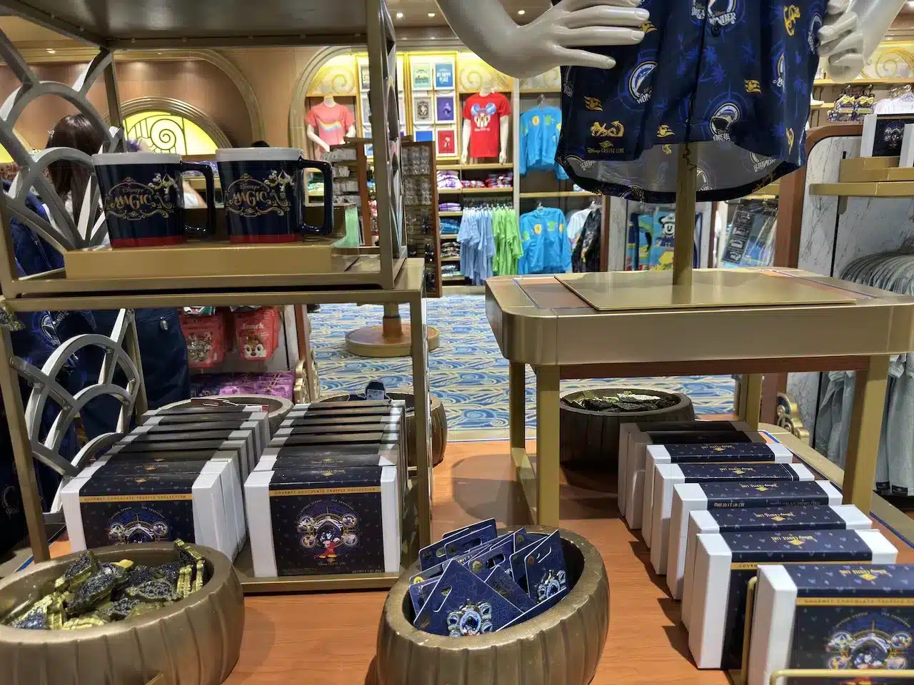 DCL Magic limited souvenirs are laid on the table at the shop on Disney Magic.