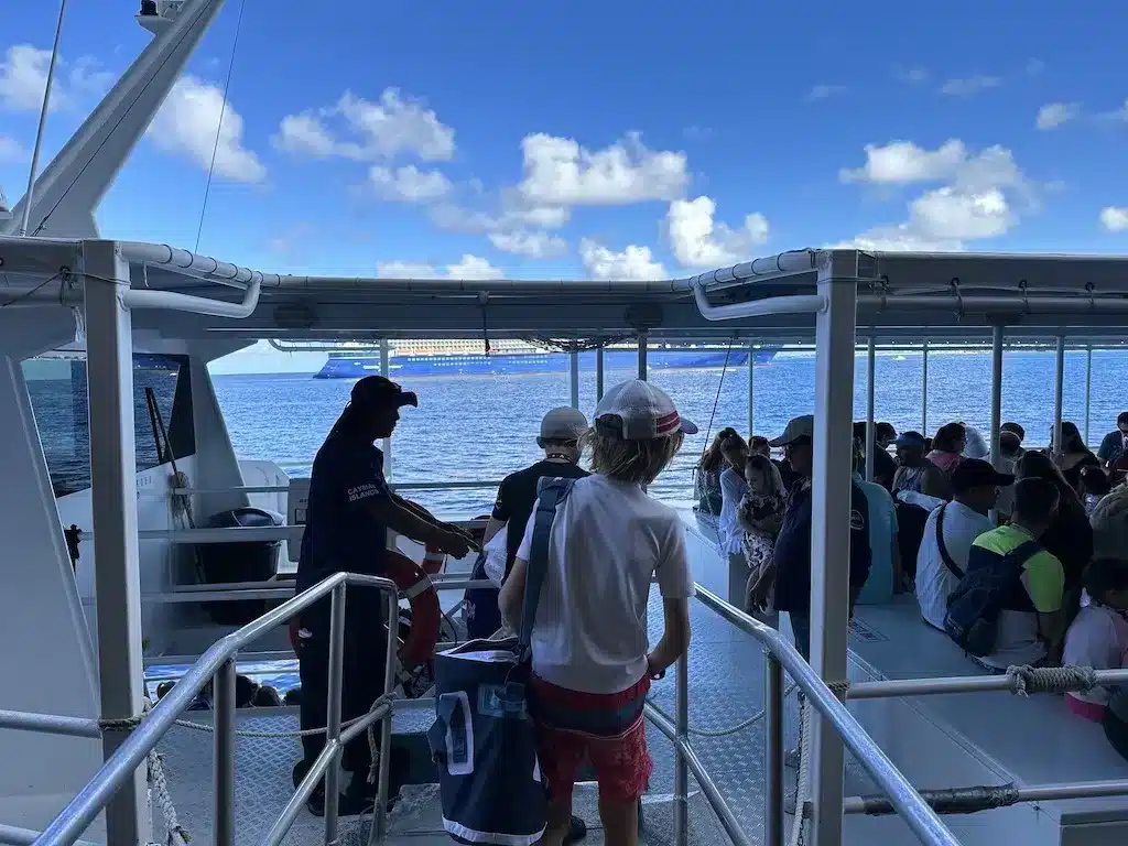 People are getting on the small boat from Disney Cruise Dream.