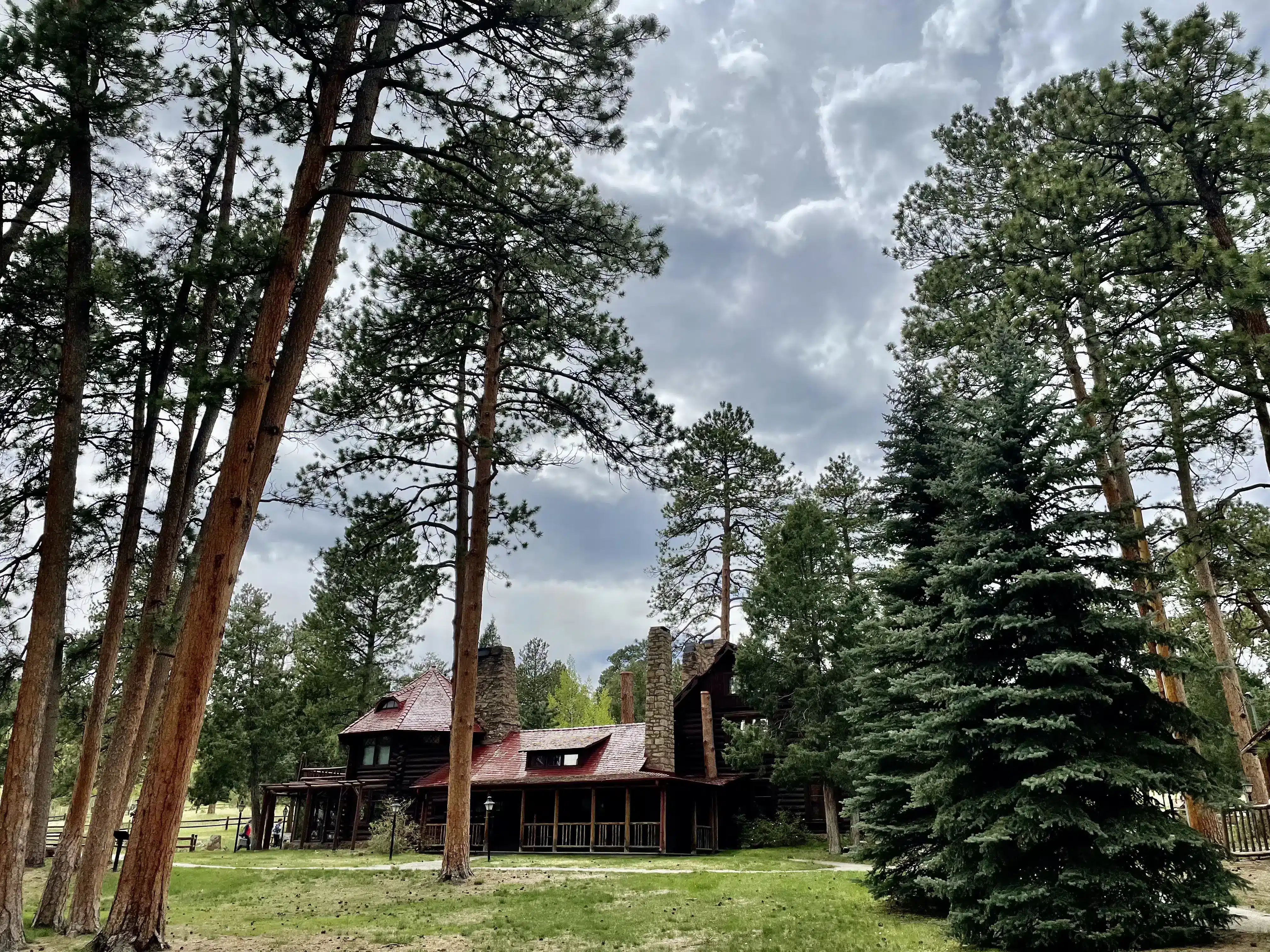 An old-fashioned building in a quiet area surrounded by tall trees