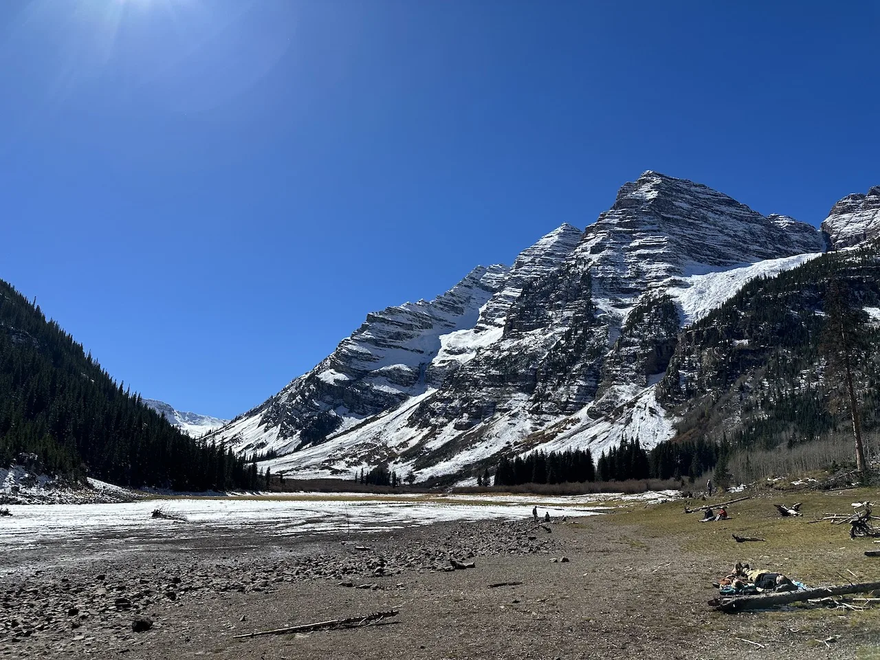 The dried up lake and snow covered mountains.