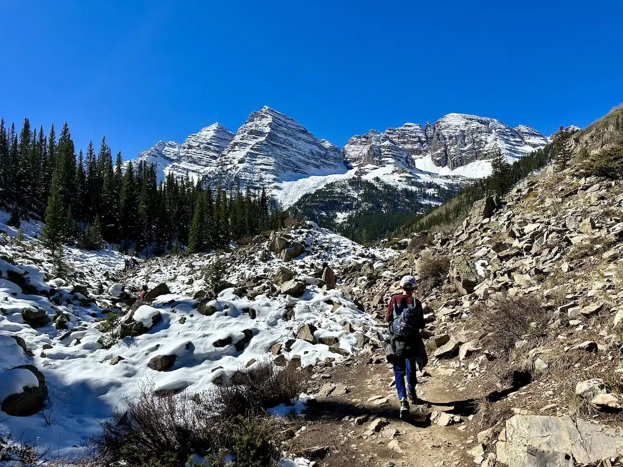 A boy is on the trail surrounded by breathtaking views.
