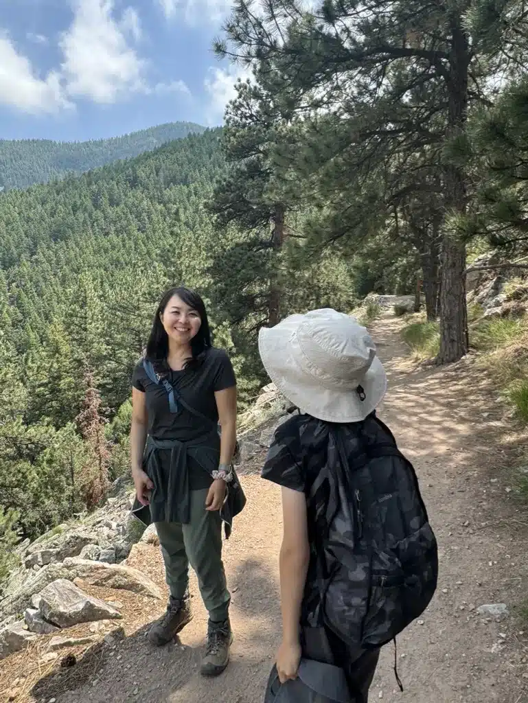 Tomo Colorado, the author of Tomo Travel Camping is standing on the trail in the mountain.