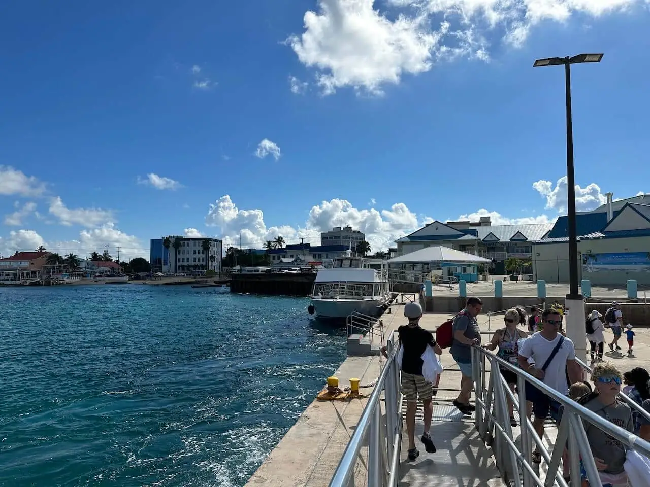 A boy is walking on the bridge by the port of Grand Cayman.
