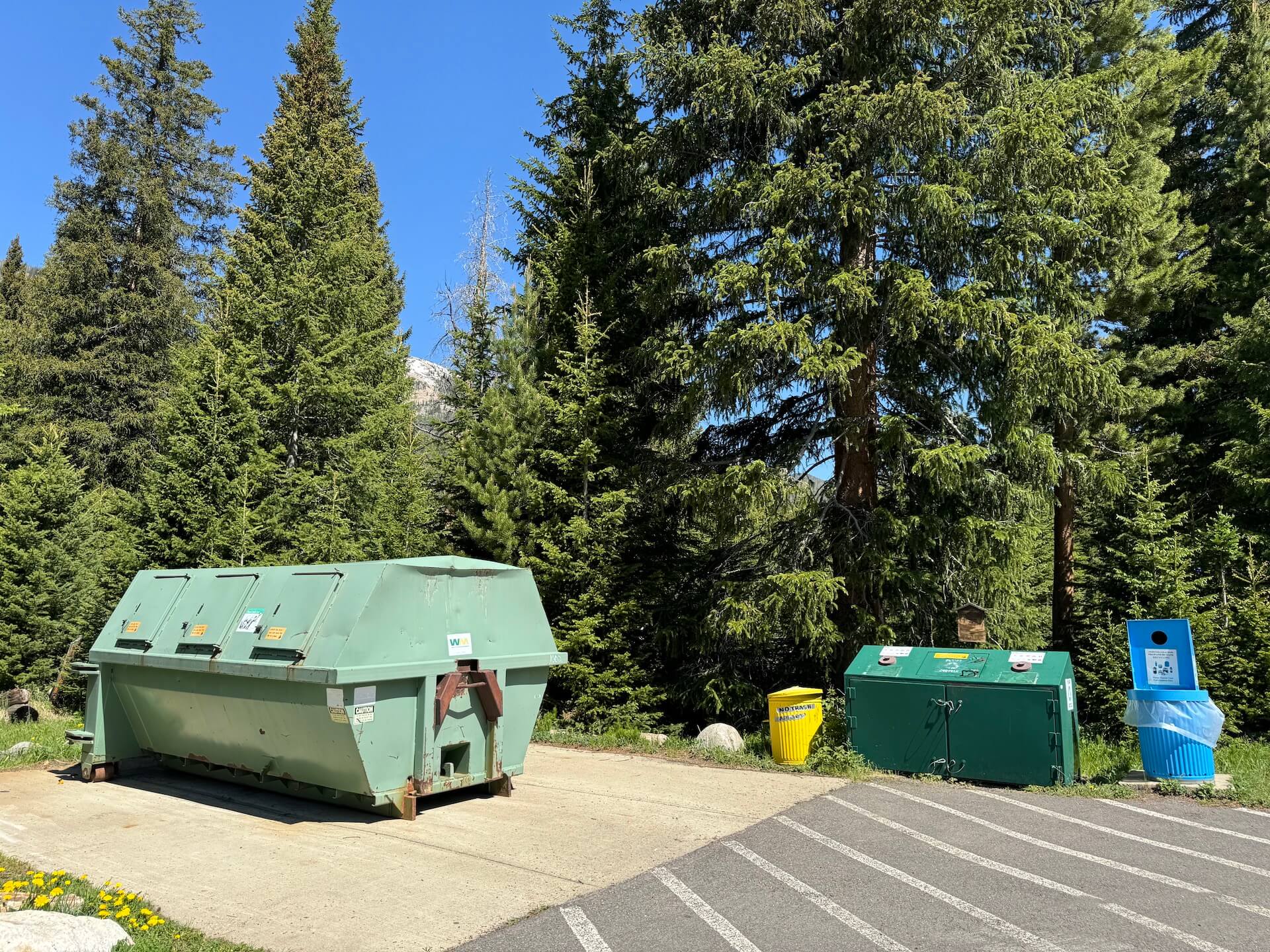 Large trash bin and a recycling area.