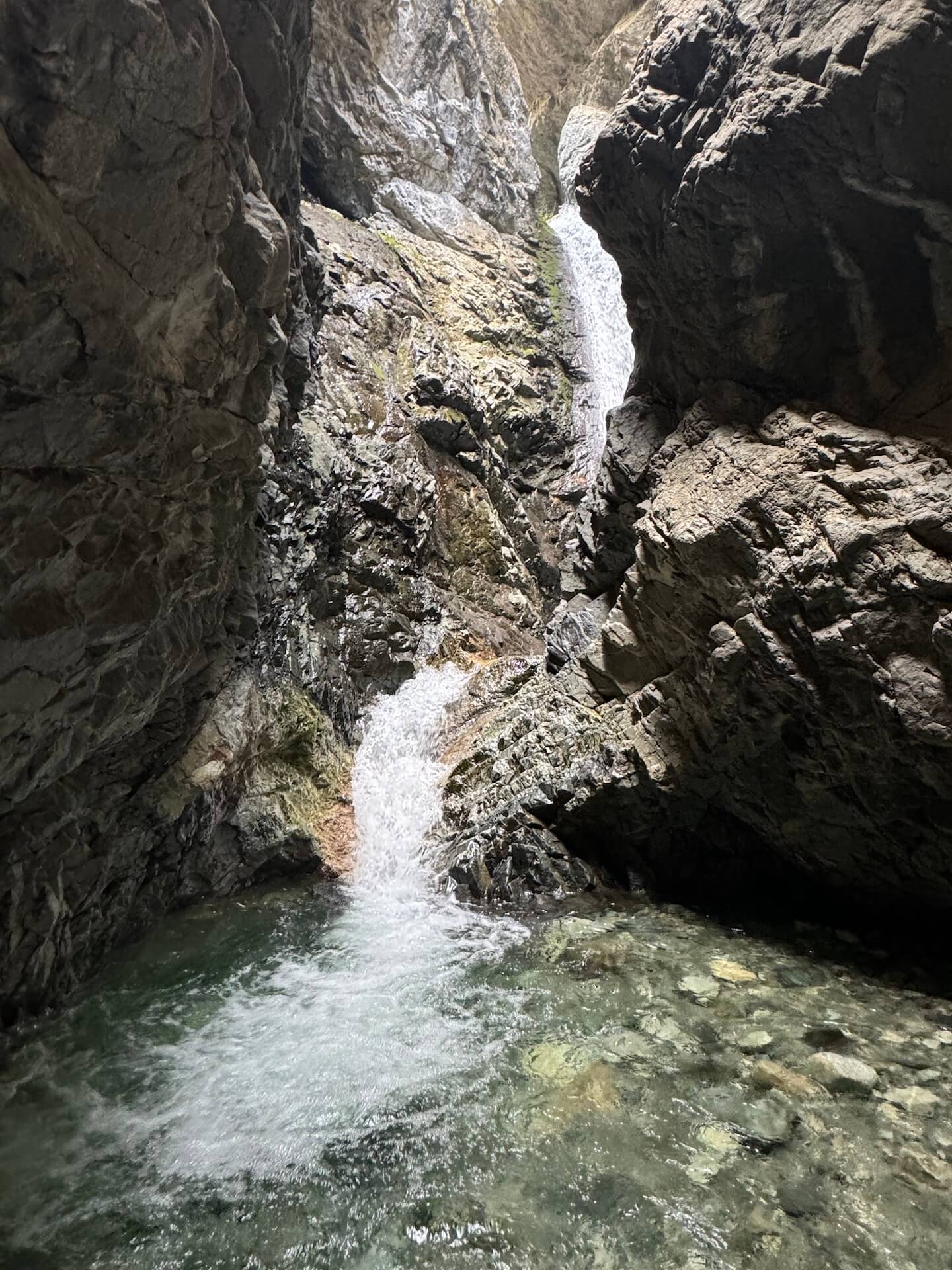 Zapata Falls cascades approximately 9 meters (30 feet) down between the rocks.