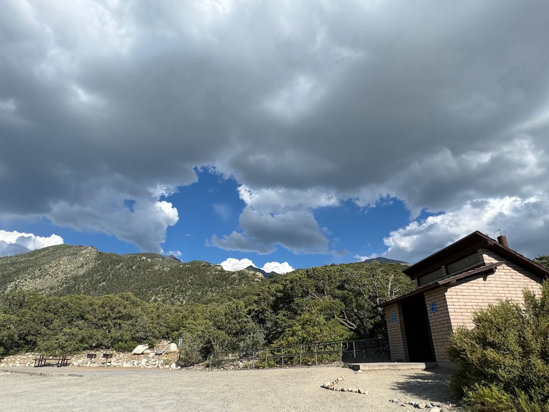 A gravel path leads to the Zapata Falls parking lot, where you'll find a restroom building and picnic benches.