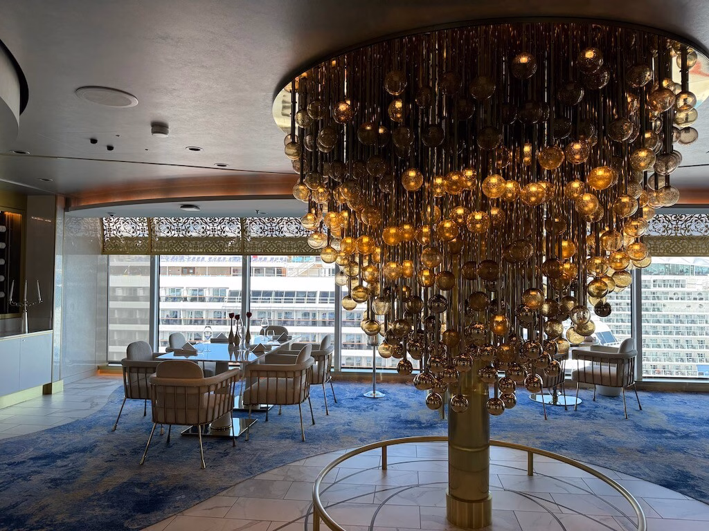 The large chandelier displayed at the entrance of Enchanté restaurant on the Disney Wish