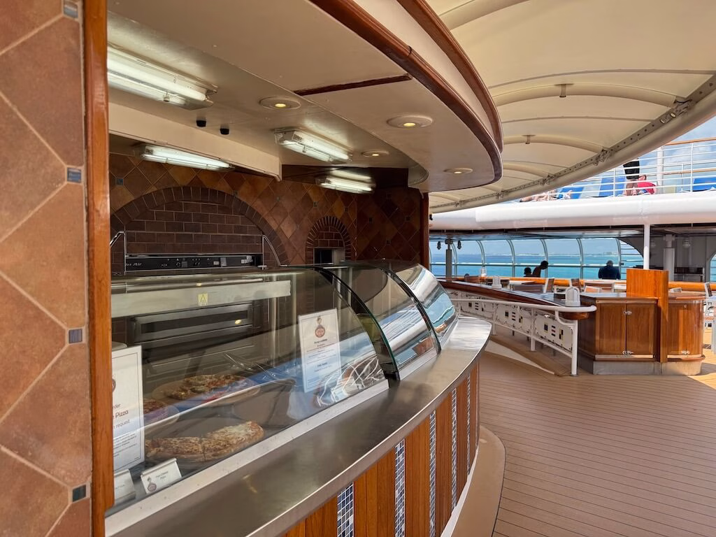 Pizza served as a quick snack on the Disney Magic cruise ship, available fresh and hot with various toppings. Guests can grab slices throughout the day as part of the complimentary dining options.