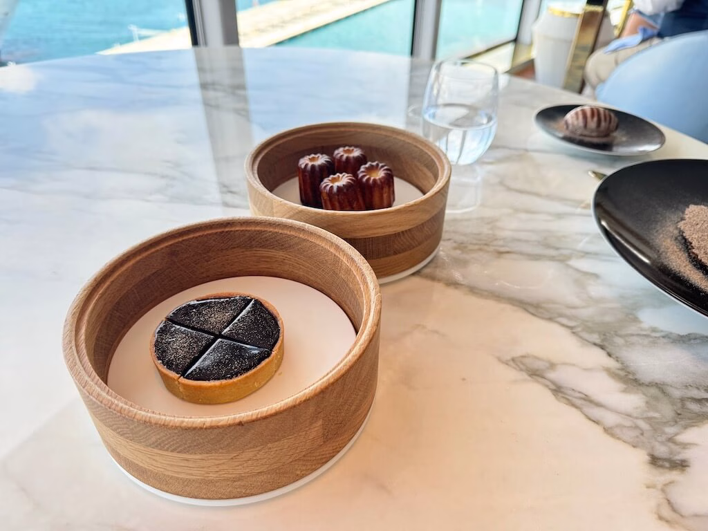The chocolate tart and canelé served as desserts at Enchanté on the Disney Wish.