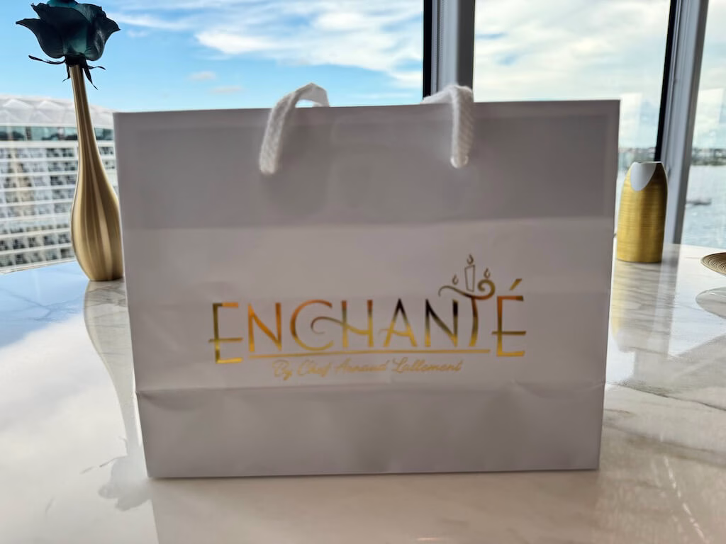 The small white paper bag you receive at Enchanté, the adults-only restaurant on the Disney Wish.