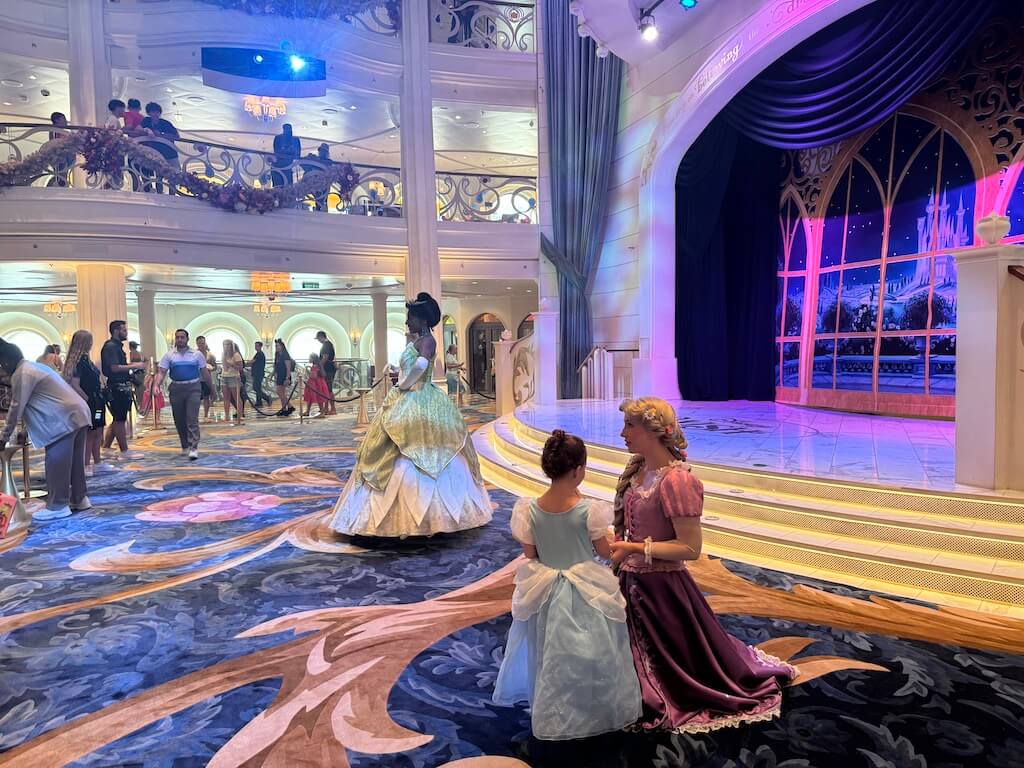 Disney Cruise_Royal Gathering Rapunzel - Tomo Travel & Camping The Versailles gardens, viewed from the palace, are a stunning display of French formal design, featuring symmetrical lawns, vibrant flower beds, sculpted hedges, and shimmering fountains that blend gracefully into the horizon.