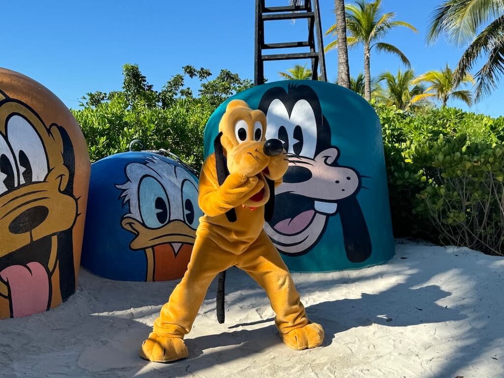 DCL_Character Greeting at Mount Rustmore on Castaway Cay - Tomo Travel & Camping Mickey is leaning on the colorful jeep in the background of Disney Cruise at Castaway Cay.