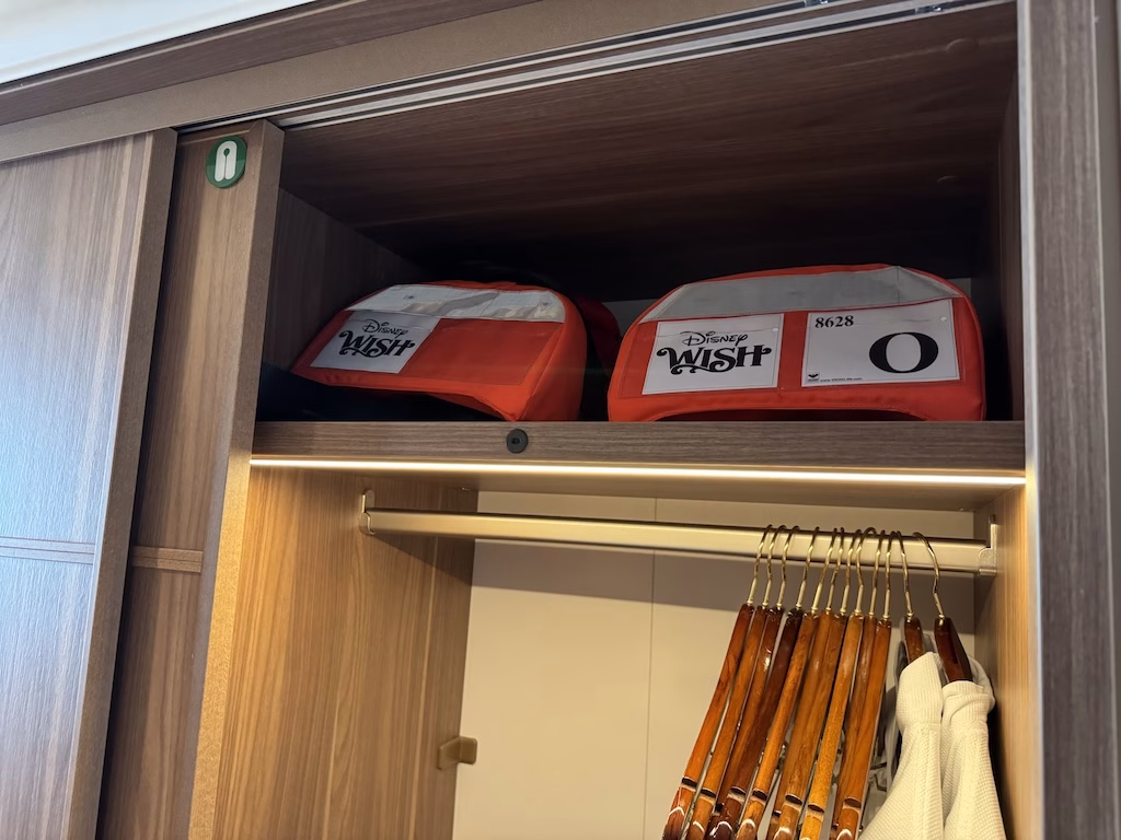 The closet inside a stateroom on the Disney Wish cruise ship contains life jackets for emergencies.