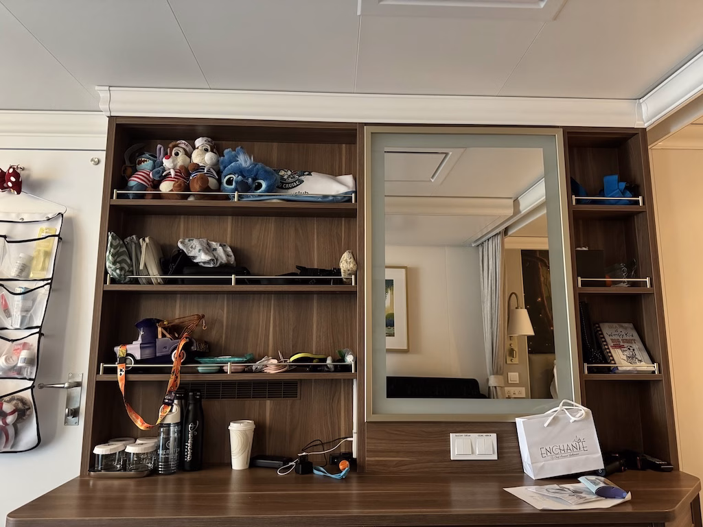 The desk in a stateroom on the Disney Wish cruise ship, featuring plenty of storage shelves.