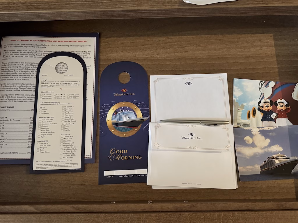 The drawer containing the room service menu and stationery inside a stateroom on the Disney Wish cruise ship.