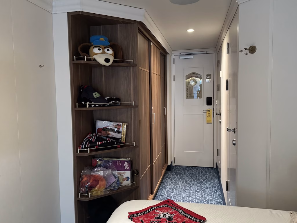The desk in a stateroom on the Disney Wish cruise ship, featuring plenty of storage shelves.