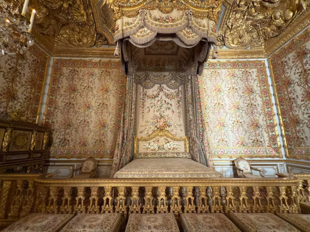 The bedroom in the Palace of Versailles once used by Marie Antoinette is a lavish space that reflects her refined taste and royal elegance.