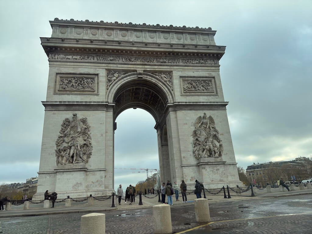 The Arc de Triomphe, a symbol of Paris and French pride, stands majestically at the center of the Champs-Élysées, honoring those who fought and died for France.