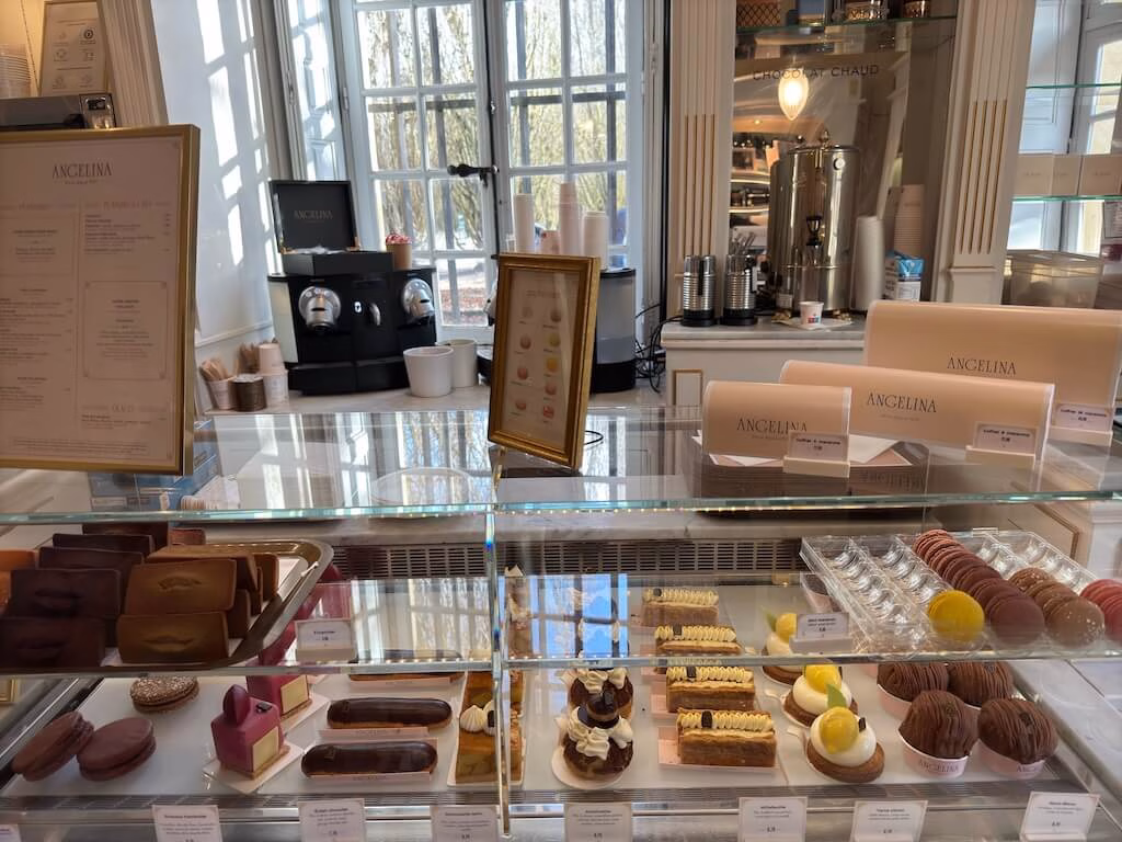 Inside the majestic Versailles Palace, the Angelina tearoom presents a tempting display of exquisite cakes and pastries.