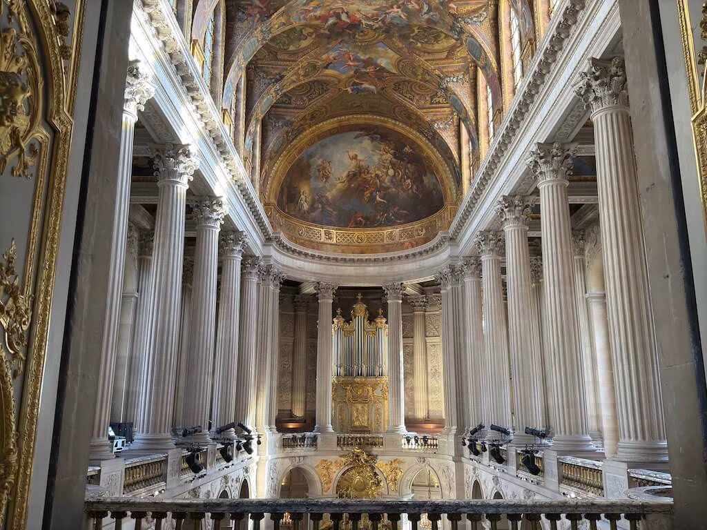 The chapel inside the Palace of Versailles is a breathtaking blend of gold and white, radiating an air of divine elegance and regal grandeur.