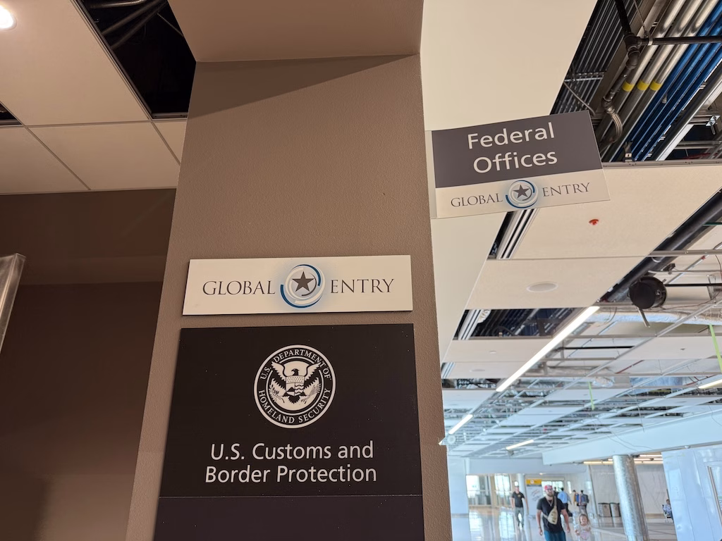 Entrance to a U.S. Customs and Border Protection office with Global Entry signage, where travelers attend interviews for Global Entry enrollment or renewal.