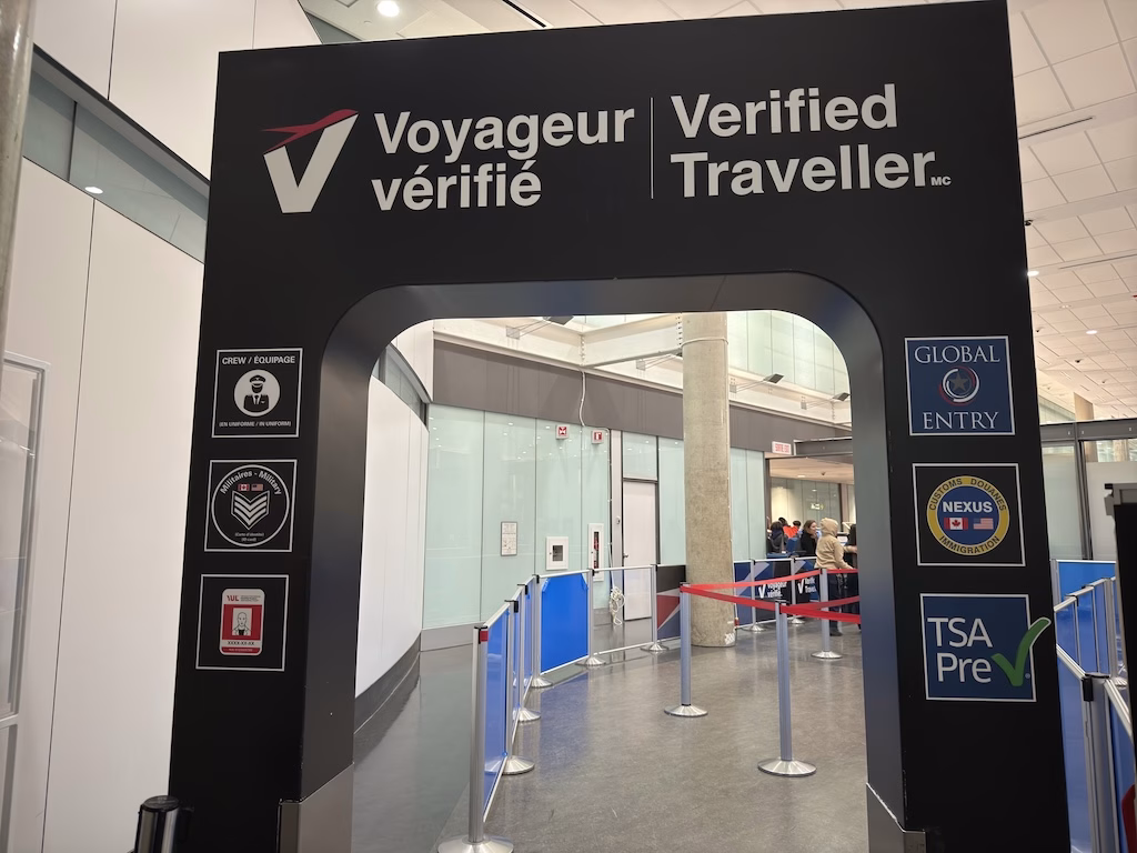 Verified Traveller lane at a Canadian airport showing signs for Global Entry, TSA PreCheck, and NEXUS, offering expedited security screening for pre-approved travelers.