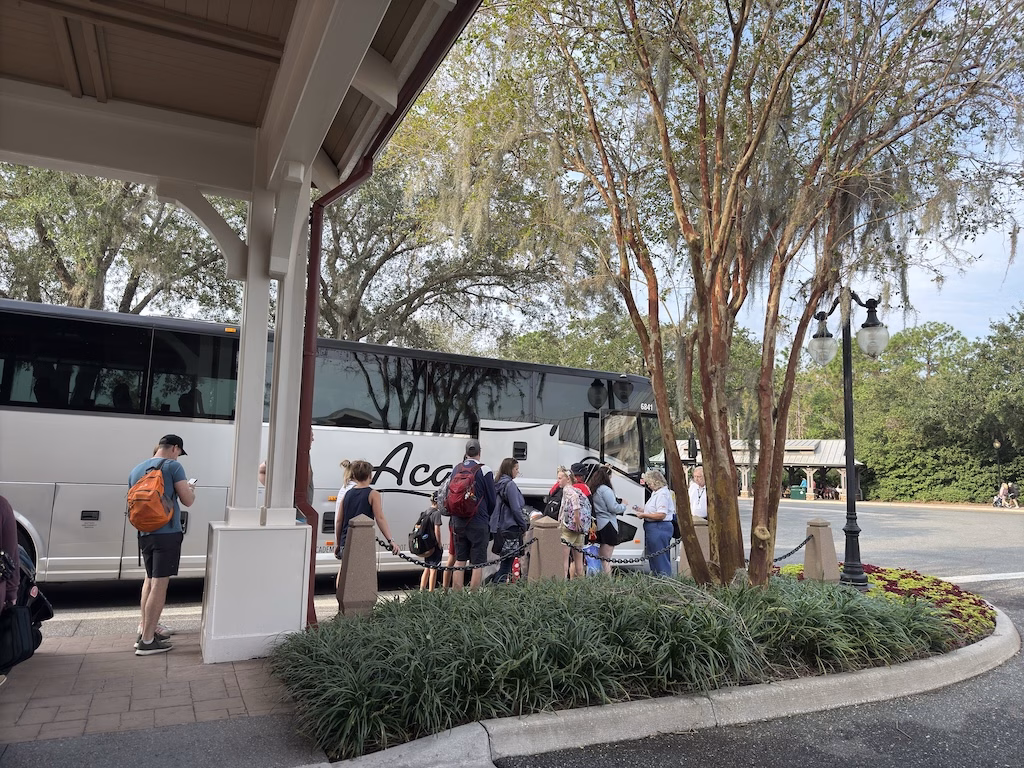 Guests lining up to board a third-party shuttle bus to Port Canaveral from a Disney Resort hotel for Disney Cruise Line ground transportation