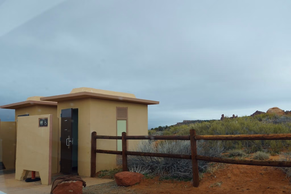 Restroom facilities at the Fiery Furnace Trailhead parking lot in Arches National Park, the last bathroom stop before starting this popular Moab hiking trail.