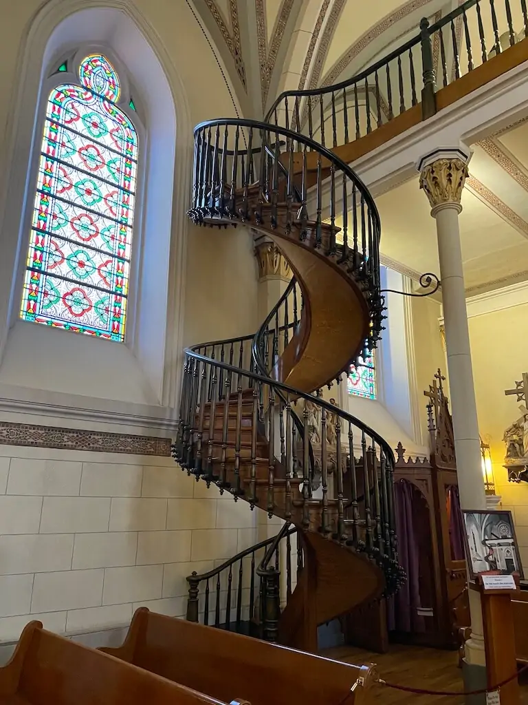 Miraculous spiral staircase inside the Loretto Chapel in Santa Fe, New Mexico—famous for its unique design and craftsmanship with no visible means of support, a must-see historic site in Santa Fe.
