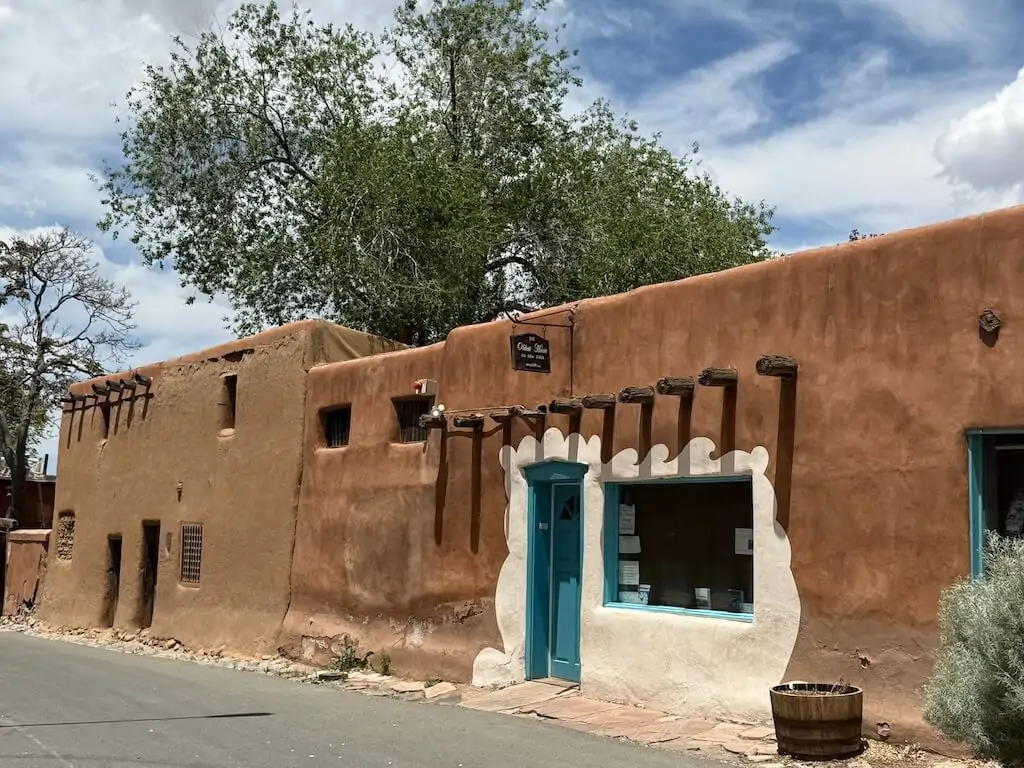 The Oldest House in Santa Fe, New Mexico, with preserved adobe walls, turquoise doors, and traditional Southwestern design—located near other historic sites and top things to do in Santa Fe.