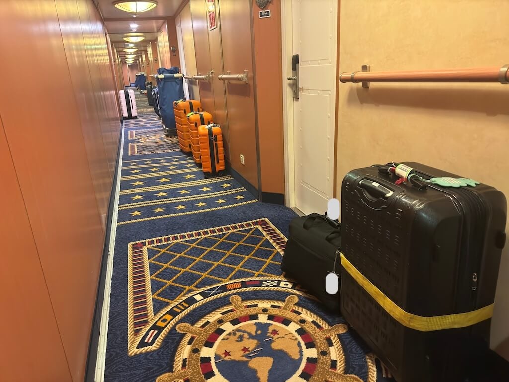 Suitcases placed outside Disney Cruise stateroom doors the night before disembarkation