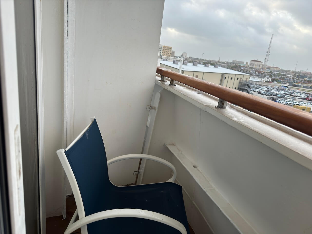 Disney Cruise Small or Obstructed Verandah Balcony - Tomo Travel & Camping Small Disney Cruise verandah balcony with chair and partial side wall view.