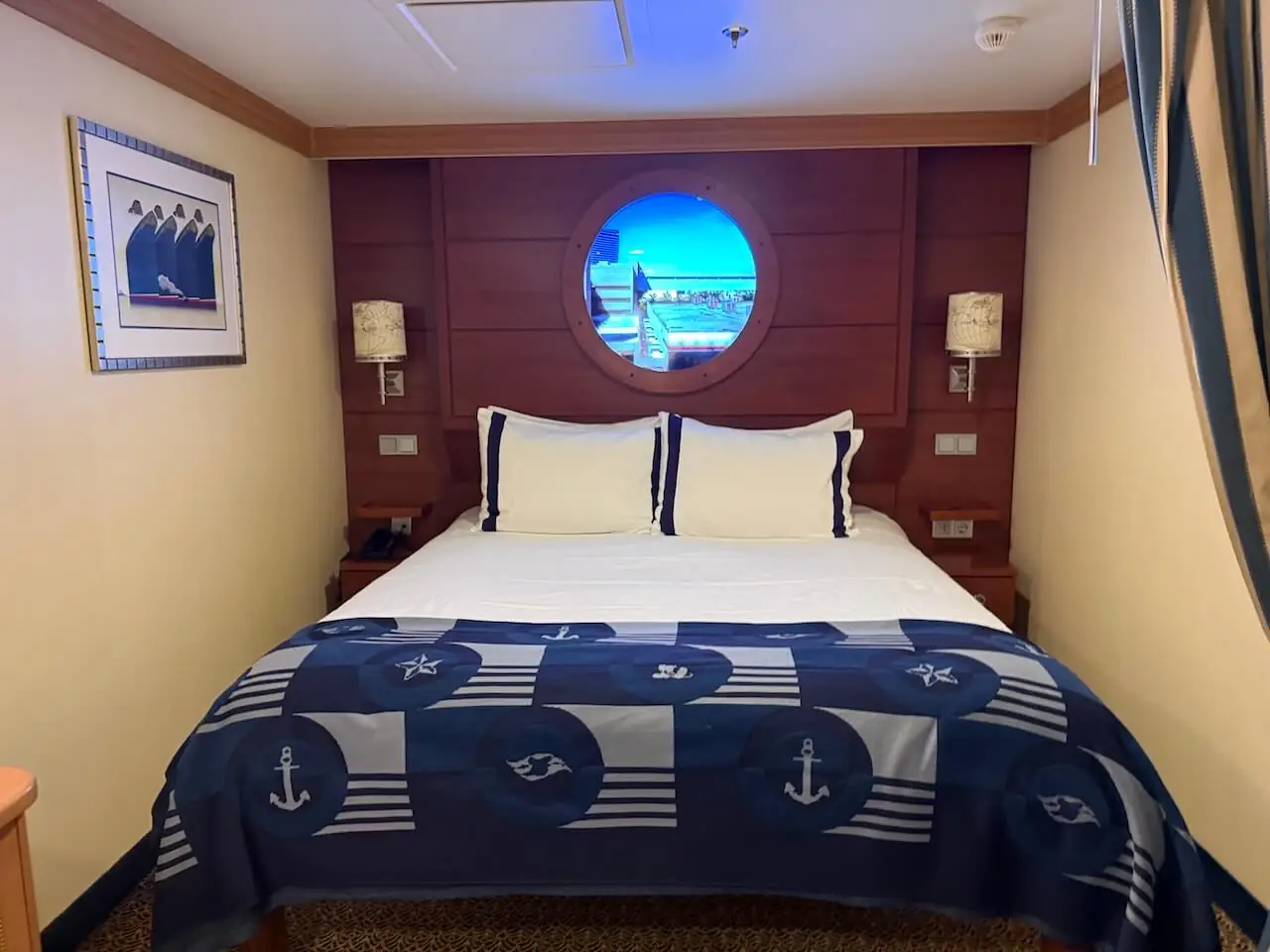 Disney Cruise inside stateroom with queen bed and porthole window, typical layout for an interior cabin or GTY guarantee room.