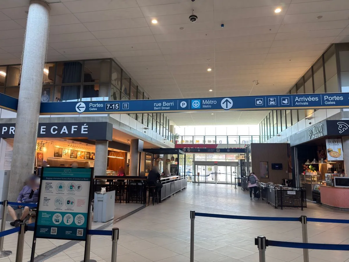 Inside the Montreal bus terminal with signs to the gates and the metro