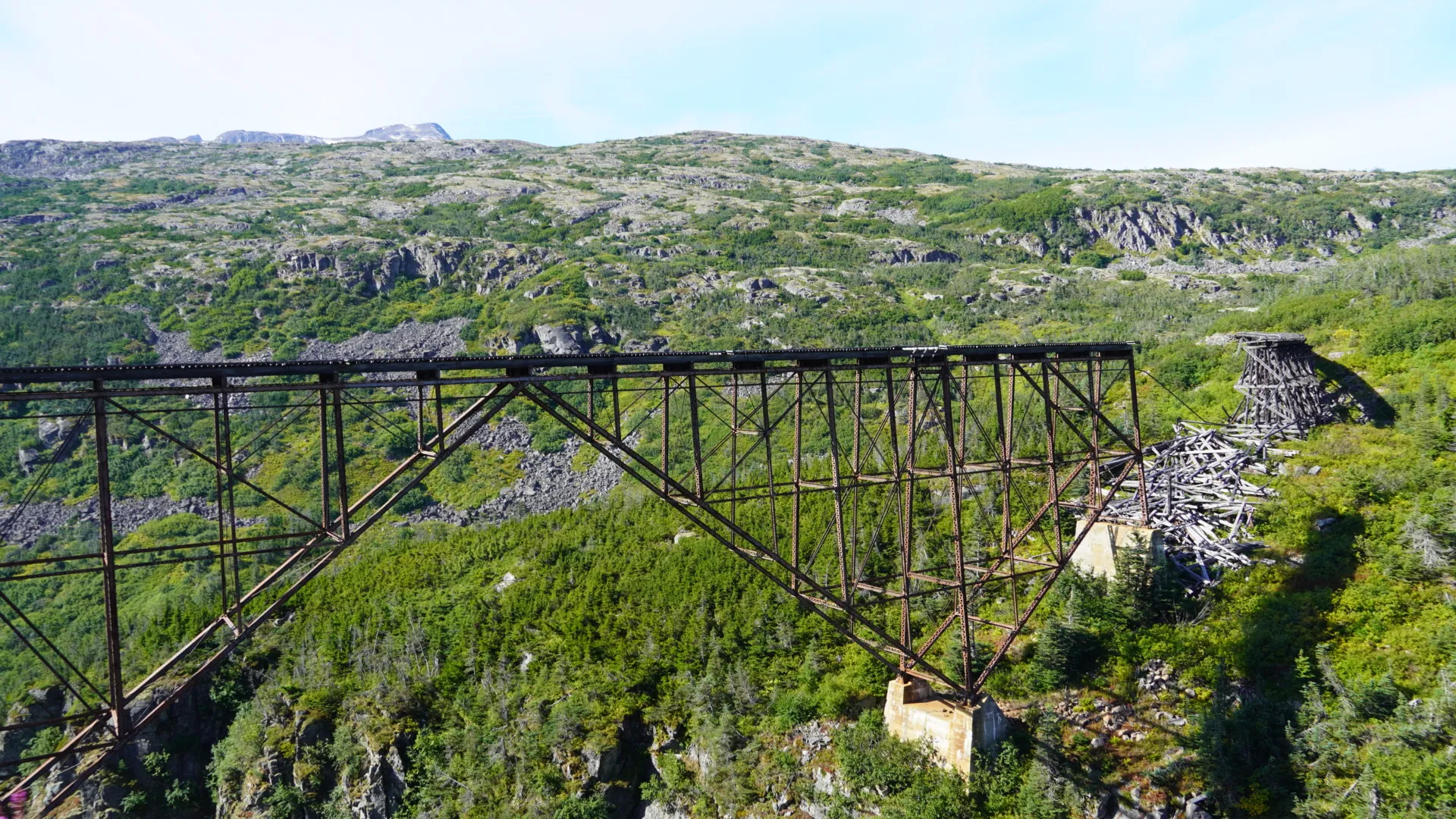 Historic steel railway bridge in the mountains along the White Pass route near Skagway, Alaska
